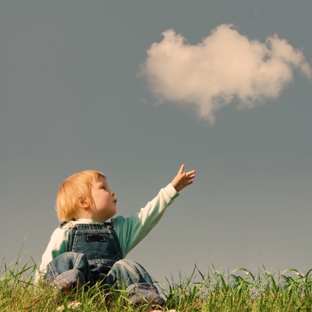 23880808 - child on green grass under blue sky