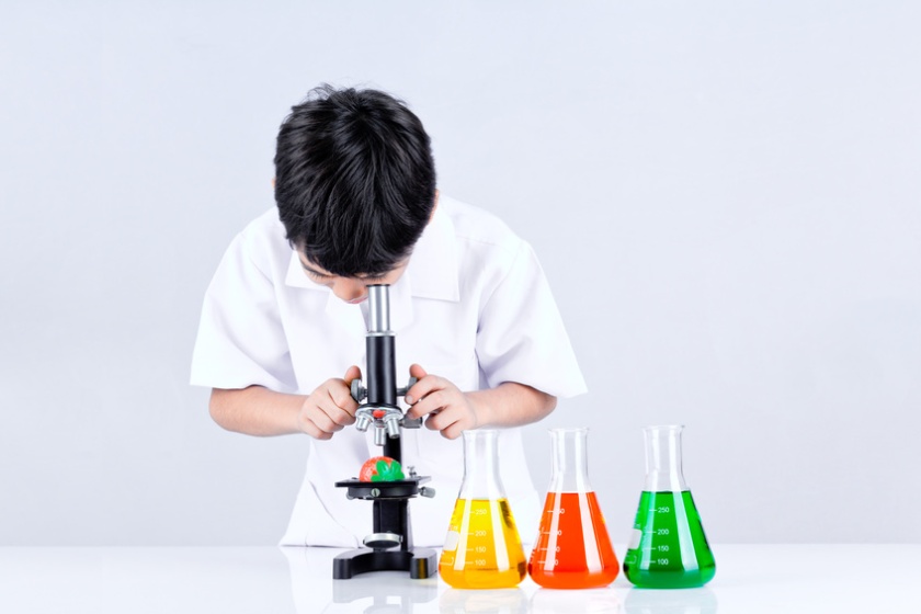 Asian boy conduct an experiment microscope
